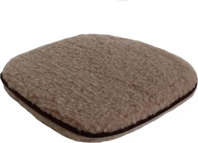 A single, light brown, fluffy seat cushion with a dark brown trim, shown from a slightly elevated diagonal angle against a white background.