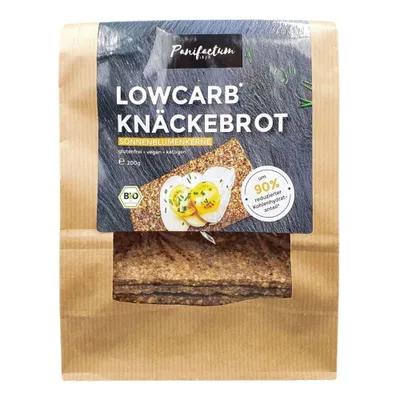 A package of low-carb crackers with sunflower seeds, shown with a topping of eggs and chives.