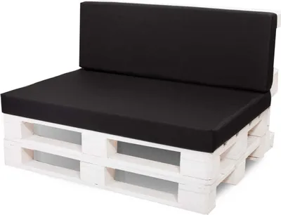 A black cushioned sofa made from white wooden pallets, shown against a white background.