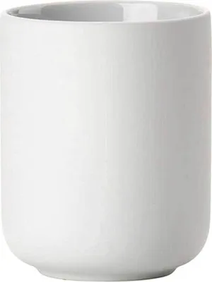 A plain white ceramic toothbrush holder.