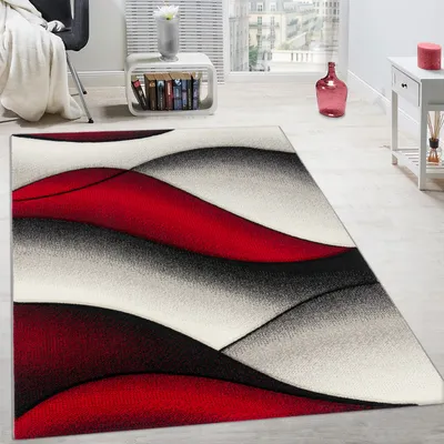 Immagine prodotto di Tappeto di design moderno con motivo astratto a onde e taglio sagomato nei colori crema, grigio e rosso. Dimensioni: 60 x 110 cm.