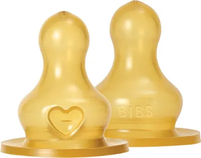 Two yellow baby bottle nipples are shown against a white background.