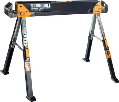 A black and orange sawhorse/jobsite table is shown against a white background.