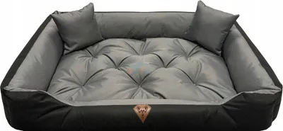 A dog bed with two small pillows on a white background.
