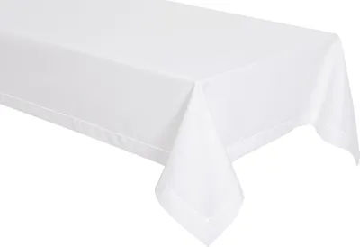 A white tablecloth is draped over a table, with one corner hanging down.