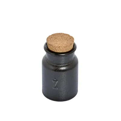 A small, dark-colored spice jar with a cork stopper, shown against a white background.