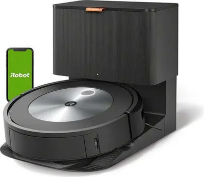 A robot vacuum cleaner and its charging base with a smartphone displaying the iRobot logo.