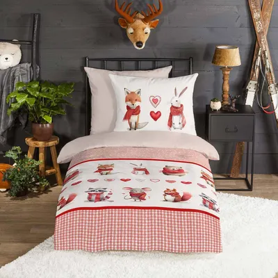 A child's bedroom with a bed dressed in themed bedding.
