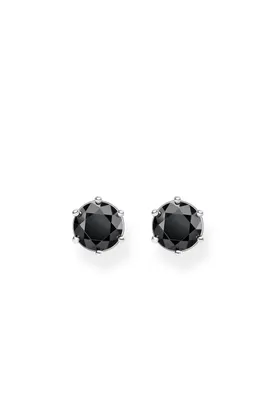 A pair of black stud earrings with silver settings on a white background.