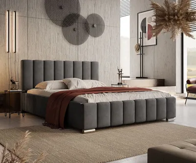 A modern bedroom with a large upholstered bed as the focal point.