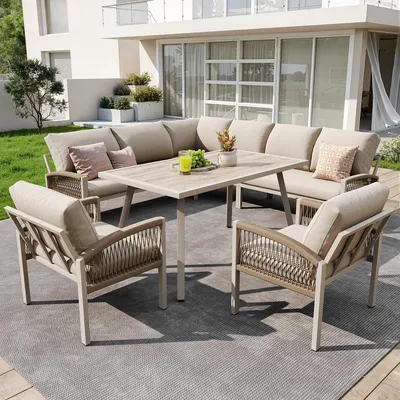 An outdoor patio setting with a sectional sofa, chairs, and a table.