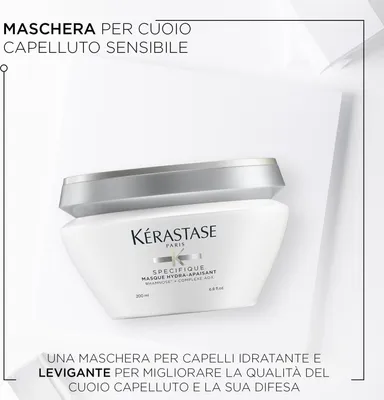 A white jar of hair mask is presented on a white surface with white geometric shapes in the background.