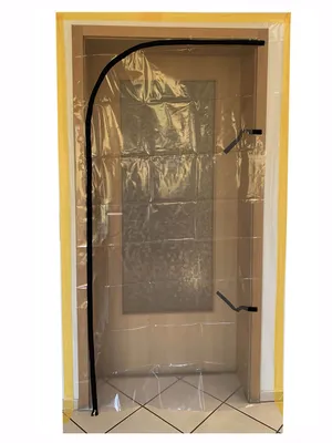 A clear plastic dust protection door with a zipper is installed in a doorway.