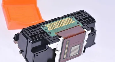 A close-up studio shot of a printer's ink cartridge head.