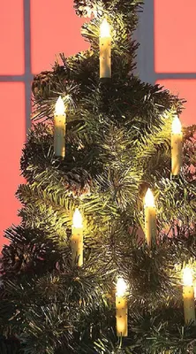 A close-up shot of a decorated Christmas tree with LED candle lights.