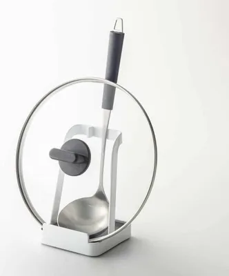 A kitchen utensil holder with a ladle and lid.