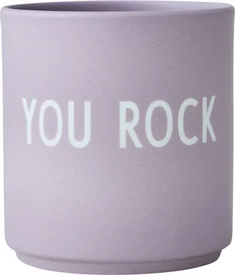 A close-up, front-facing view of a lavender mug with white text.