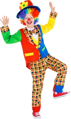 A child dressed as a clown, posing with arms outstretched.