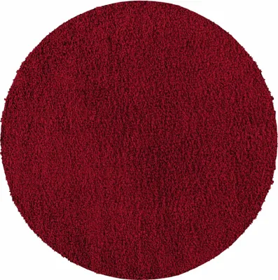 A circular, red, shaggy rug.