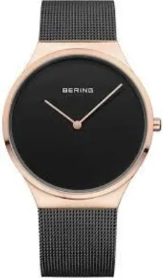 A close-up studio shot of a Bering men's watch with a black dial and rose gold case and mesh strap.