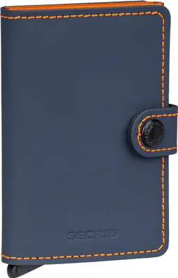 A blue Secrid wallet with orange stitching and a black snap closure.