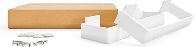 A cardboard box and white plastic furniture legs are arranged on a white background.