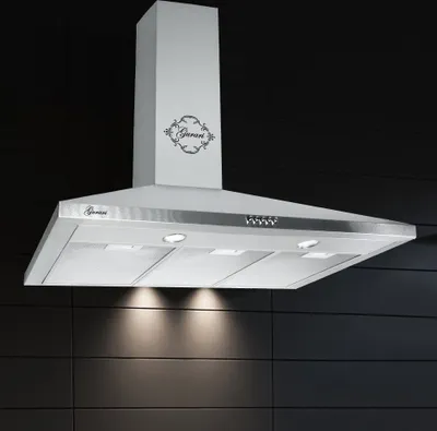 A stainless steel range hood is shown against a dark tiled wall.