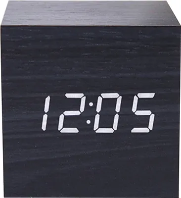 A close-up of a black digital alarm clock displaying the time.