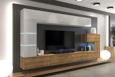 A modern living room entertainment center with a TV, shelves, and cabinets, illuminated by LED lights.