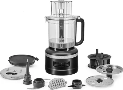 A black KitchenAid food processor with various attachments displayed around it on a white background.