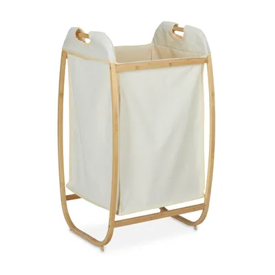 A cream-colored laundry basket with a bamboo frame, shown against a white background.