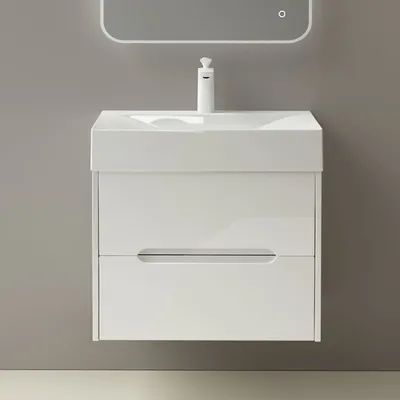 A white bathroom vanity with a sink and faucet against a gray wall.