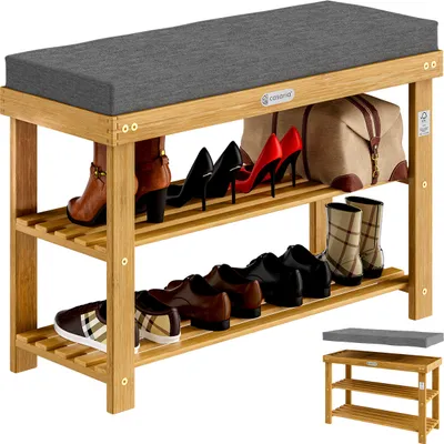 A multi-tiered shoe rack with a cushioned seat, displaying various shoes and a bag.