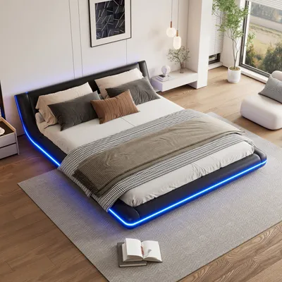 A modern bedroom with a black upholstered bed frame featuring blue LED lighting, a white nightstand, and a large window.
