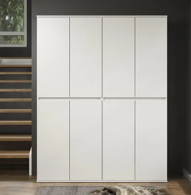 A large, white, eight-door wardrobe is shown in a room with a dark gray wall and wooden stairs.