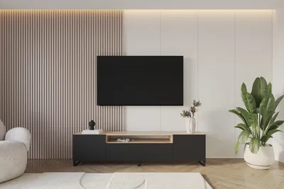A modern living room with a TV stand and a large television mounted on the wall.
