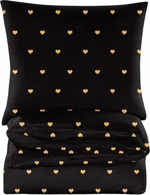 A folded duvet and pillow set with a black background and gold heart pattern.
