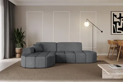 A modern living room with a sectional sofa, floor lamp, and artwork.