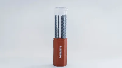 A set of Hilti hammer drill bits in a clear plastic case with an orange base.