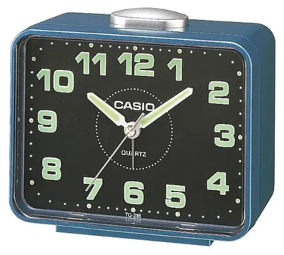 A close-up studio shot of a blue Casio alarm clock with a black face.