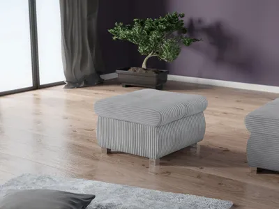 A modern pouf with a striped fabric cover sits on a wooden floor next to a large window with grey curtains. A bonsai tree in a dark planter is visible in the background against a purple wall.