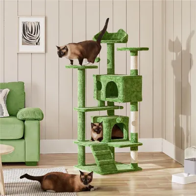 A living room scene with a green cat tree and two cats.