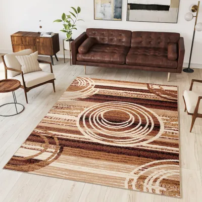 A living room scene with a sofa, armchair, side table, and a rug.