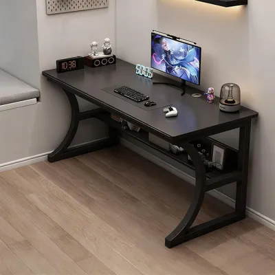 A black steel desk with a computer setup in a room.