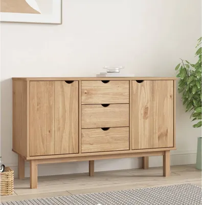 A wooden sideboard with drawers and cabinets is displayed in a room with a plant and a picture on the wall.