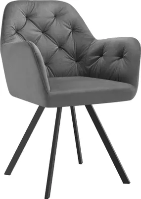 A studio shot of a gray velvet armchair with black metal legs.