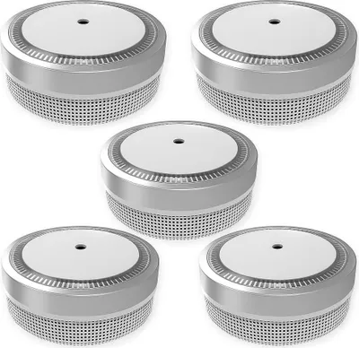 A group of five smoke detectors arranged in a grid on a white background.