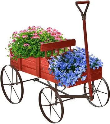 A red wooden wagon filled with pink and blue flowers, set against a white background.