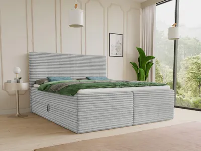 A bedroom scene with a bed, nightstand, and a large window overlooking a forest.