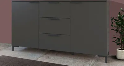 A dark gray sideboard with three drawers and two doors, shown from a front-side angle on a tiled floor.